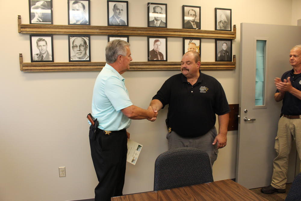 Photo of Sheriff Clague congratulating Lt Jason Landers on his promotion.